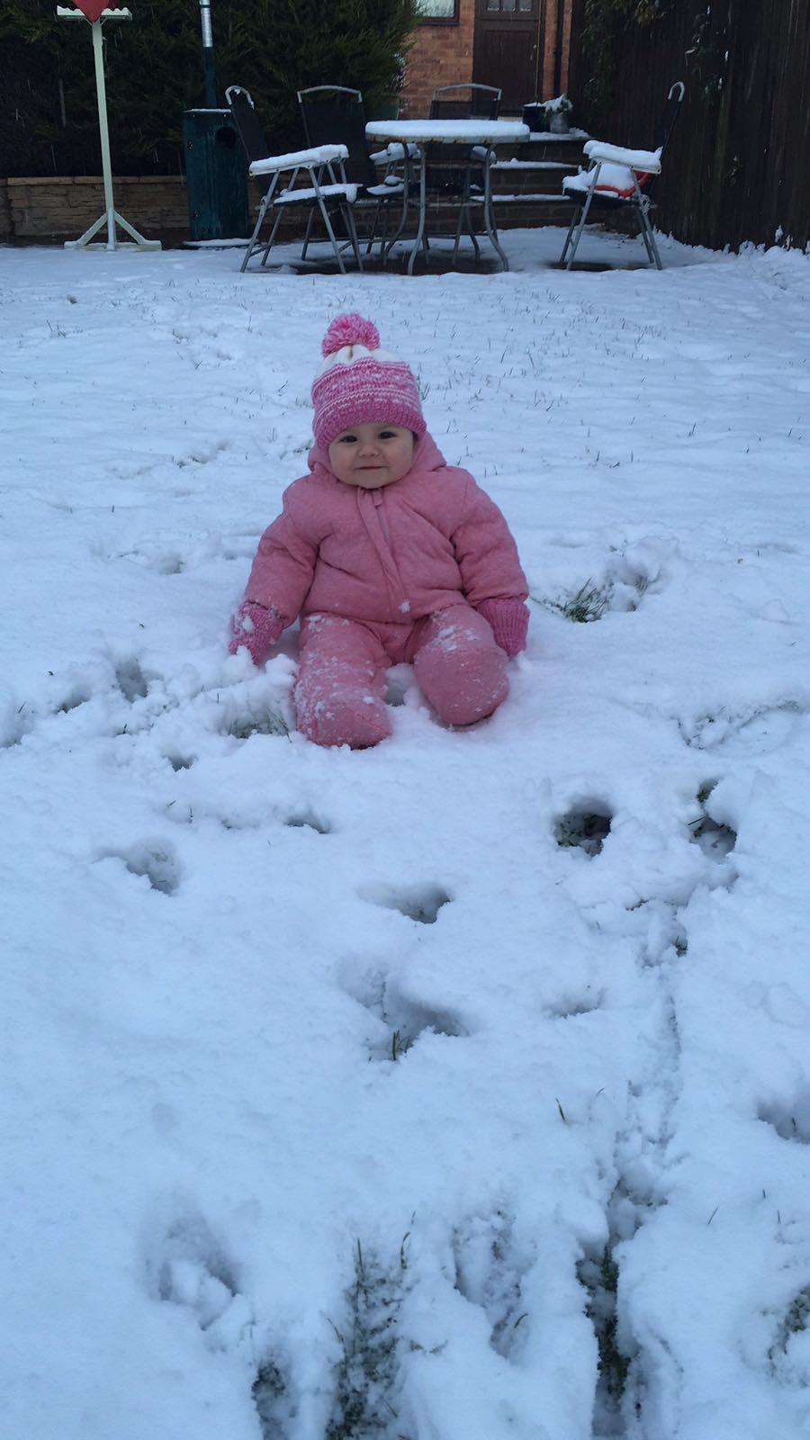 10-month old Francesa Vasey enjoys her first experience of snow in Scarborough.