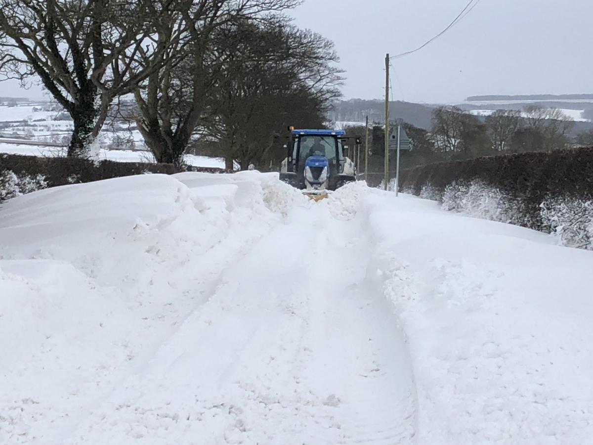 Tractor plowing road at top of hill on Langton road  by Jonny Allen