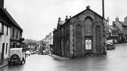 Pickering: the building in the centre, at the junction of Burgate and Market Place, known as The Vaults, was demolished in the middle of the last century. Barber Fred Pickering had his premises on the first floor.