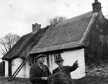 Seth Eccles, left, of Helmsley, who was thatching this cottage at Beadlam, talks to George Bumby in 1953.