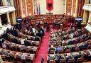 Members of the Democratic Party (left) look on as lawmakers of the ruling Socialist party vote in the Albanian Parliament (Armando Babani/AP/PA)