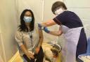 Elizabeth Lowery, Medical Lab Assistant being vaccinated by Carol Halton, Matron