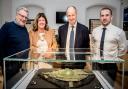 Phil Crabtree, Chairman of Malton Museum, Paula Ware, from MAP Archaeological Practice, Kevin Hollinrake MP and Scott Waters, Managing Director for Persimmon Yorkshire with the shield which was displayed at the museum earlier this year.