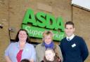 Asda staff Wendy Fielden, back left, and Gary Davies, back right, hand a dontation from the store to Laura, mum Emma Robertson-Tierney and Laura’s boyfriend Jaden Thorp