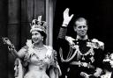 Coronation Day, and the new monarch and Prince Phillip wave at the crowds