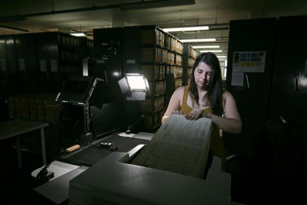 Gazette & Herald: Photo via PA shows Findmypast technician Laura Gowing scans individual pages of the 30,000 volumes of the 1921 Census at the Office for National Statistics (ONS) near Southampton.
