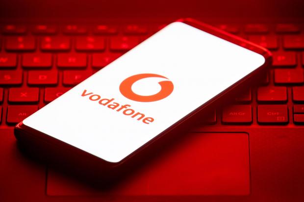 Gazette & Herald: Vodafone logo on a phone placed on a keyboard. Credit: PA