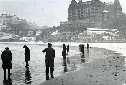 An unusual picture of beachcombers on the snow-covered sands of Scarborough's South Bay.