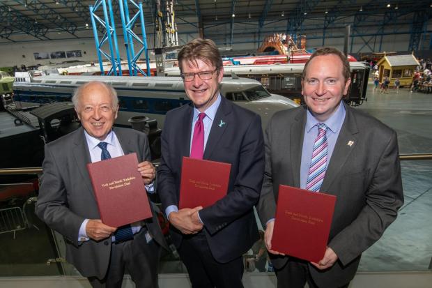 North Yorkshire County Council’s leader Carl Les (left), the Secretary of State for Levelling Up, Housing and Communities Greg Clark (centre) and City of York Council’s leader Keith Aspden (right) with signed copies of the proposed devolution