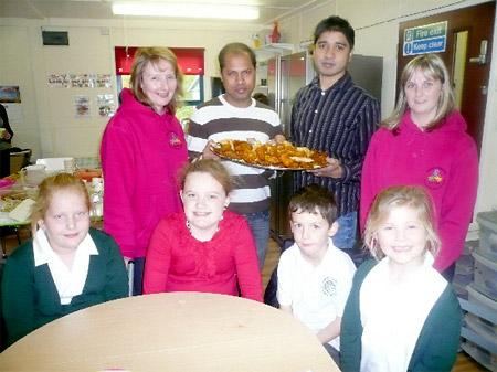 Mohammed Jahid and Lee Nafiz, from Malton Spice, serve some treats to Lucy MacPhee, Poppy Suff, Jack Machen and Amelia MacPhee and Housemartins out-of-school club staff Janet Dale and Joanne Preston