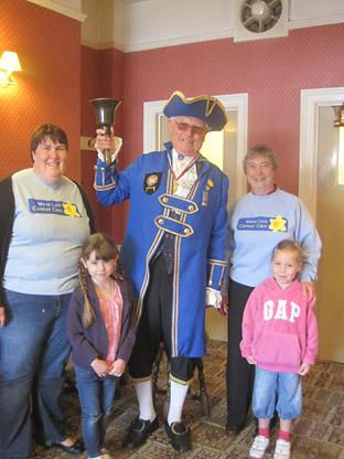 Two young visitors join two of the organisers Liz Cleworth (left) and Pat Elener (right) and town crier David Jackson at the Marie Curie Cancer Care event at Malton Conservative Club