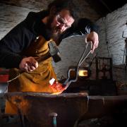 Piers Edsall working the iron with his hammer, anvil and hammer in his workshop near Terrington   Picture: Frank Dwyer