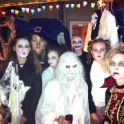 Sarah Walker, second from left, in her friend’s garage that would be transformed into a witches’ grotto for Halloween