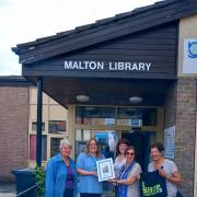 A Toilet Twinned Town certificate was presented to Malton Library staff