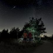 Mountain bikers looking at the night sky at Sutton Bank. Credit: Steve Bell.