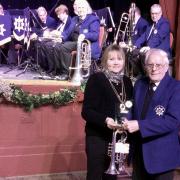 John Taylor is presented with a long-service trophy from North Yorkshire Cllr and Deputy Mayor of Malton Lindsay Burr for 73 years with Malton White Star Band .