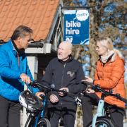 Rob Brown from Dalby Forest Cycle Hub, who has been nominated for Visit England's Tourism Superstar award, shows a couple how to use E-bikes