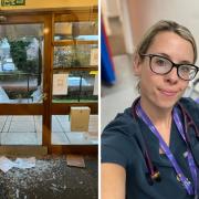 The damaged glass door at the GP surgery in Hull Road in York with Dr Abbie Brooks