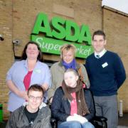 Asda staff Wendy Fielden, back left, and Gary Davies, back right, hand a dontation from the store to Laura, mum Emma Robertson-Tierney and Laura’s boyfriend Jaden Thorp