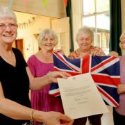 Sheila Harrison, Mary Gray, Margaret Sellers and Josie Thrower with their letter from Buckingham Palace
