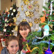 Emma Dwan and Rebecca Borthwick looking at the Chinwaggers tree on show at the Christmas tree festival at St Peter’s Church, in Norton