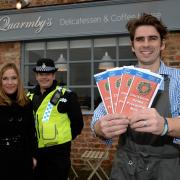Will Quarmby, from Quarmby’s Delicatessen and Coffe House, in Sheriff Hutton, with Christmas Crime Prevention menus, which will be available to customers, provided by Gail Cook, from Ryedale District Council, left, and PCSO Nicki Pounder