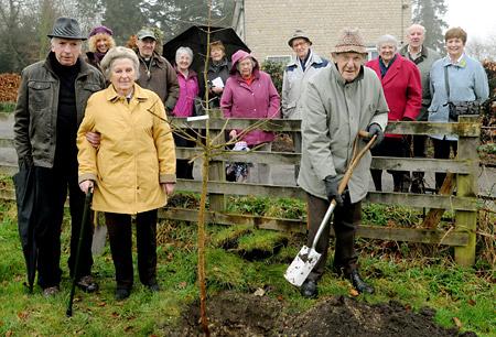 Ethel Johnson, 91, aided by James Robson, and 82-year-old Derrick Watson plant a
field maple at the Millennium Garden, in Kirkbymoorside, to commemorate the marriage of Prince William and Kate Middleton, watched by Rev Mark Brosnan and other
parishioner