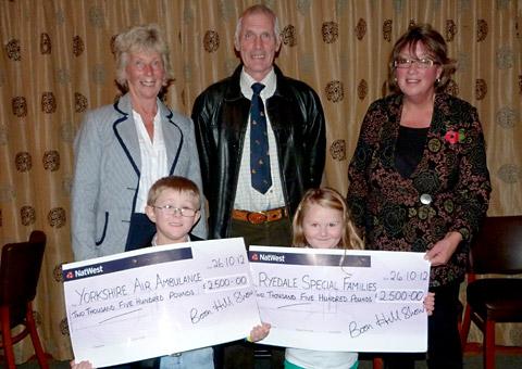 Bob Gibson, chairman of Boon Hill Show, presents
£2,500 each to Anne Baron, left, of Yorkshire Air Ambulance, and
Libby Cass of Ryedale Special Families, helped by Reece and Erin
Woodmansey.