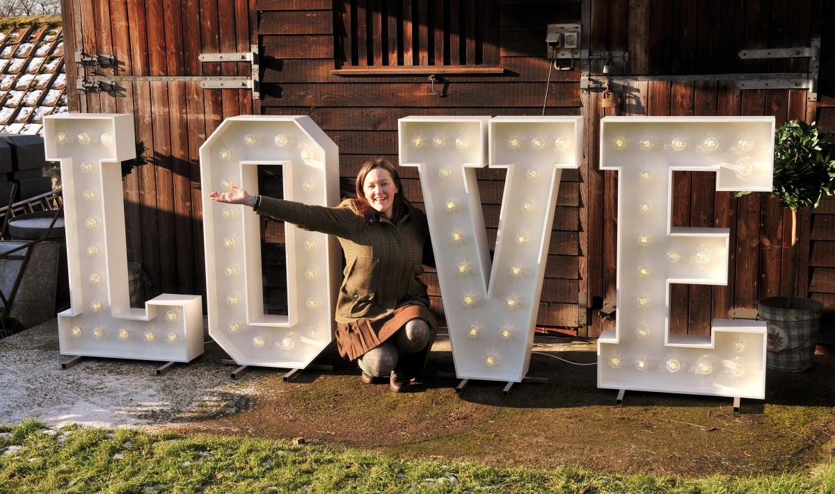 Emily Slingsby with a love sign made by her dad Phil Thompson, which is one of the many items Emily has for hire from her new business, Fabulously Finished, in Ampleforth