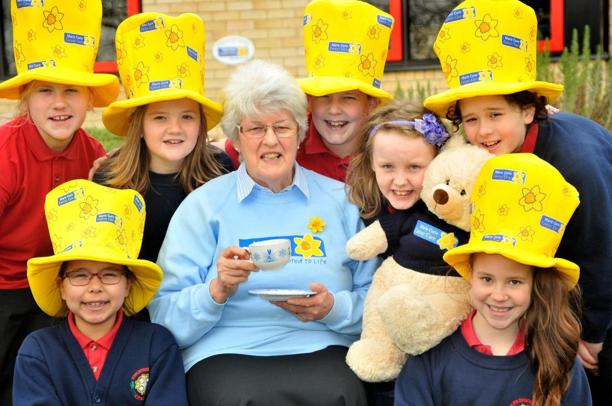 June Cook, from Marie Curie Cancer Care, with pupils from Kirkbymoorside Primary School, prepare to raise funds for the charity at a coffee morning next month.    