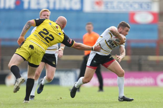 The Press' York City Knights man of the match, Ben Cockayne, skips past North Wales Crusaders' ex-Knight, Brad Brennan, during the Betfred League One encounter at Bootham Crescent. Picture: Gordon Clayton
